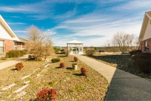 An outdoor walkway and pavilion at a skilled nursing facility for long term care, short term care, and respite care residents